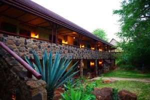Stone lodge exterior with veranda at Kilaguni Serena Safari Lodge