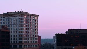 Modern four-star hotel complex exterior lit at colorful sunset